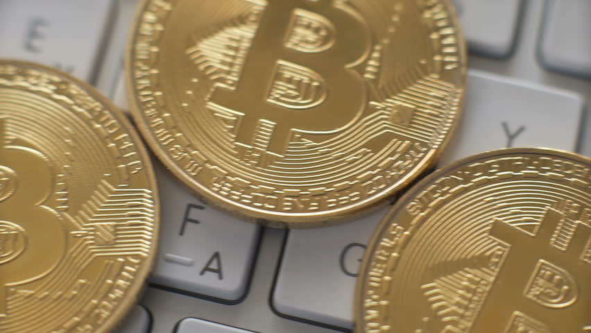 Golden bitcoins on a white keyboard background | Shutterstock HD Video #1007795722