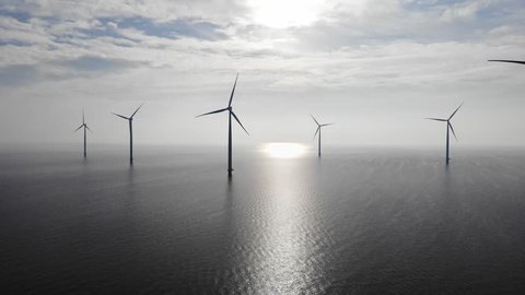 Offshore Windmill farm in the ocean  Westermeerwind park , windmills isolated at sea on a beautiful bright day Netherlands Flevoland Noordoostpolder, Drone view from above out the sky bird eye view