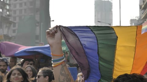 Supporters and participants of Gay or LGBT pride Parade waving colorful rainbow or pride flag, Mumbai, India (2018)
