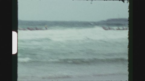 PERTH, AUSTRALIA, MARCH 1971. Competing LIfeguard Teams In Rescue Boats Rowing Over The Waves During The Australian Surf Life Saving Championships