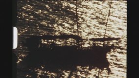 PATTAYA, THAILAND, MAY 1978. Zoom Out From A Silhouetted Yacht Sailing In The Golden Glistening Sea, Travelin At Sunset.