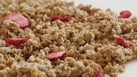 Close-up of dried strawberries in muesli breakfast 4K 2160p 30fps UltraHD panning footage - Pile of dehydrated crunchy cereals slow pan 3840X2160 UHD video