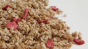Crunchy cereals shallow DOF 4K 2160p 30fps UltraHD footage - Tilting over muesli with strawberry flavour close-up 3840X2160 UHD video