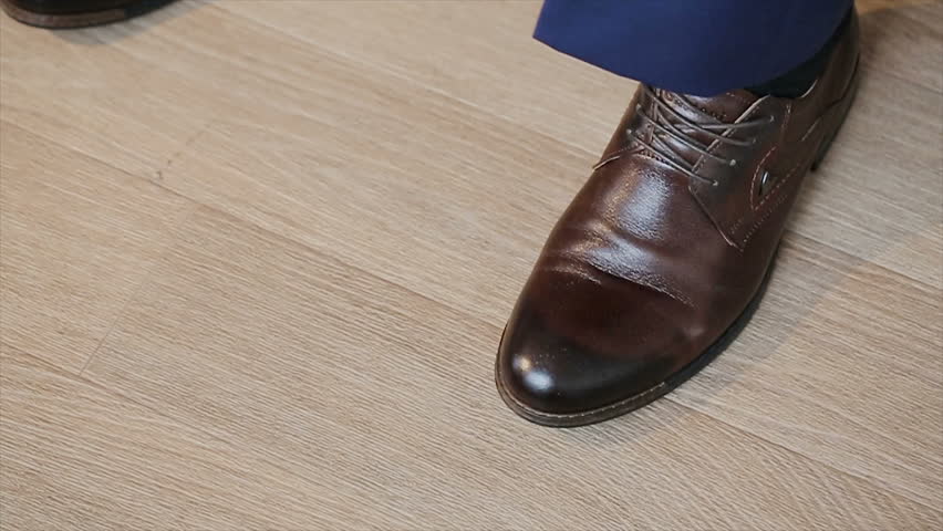 a man ties up his shoelaces