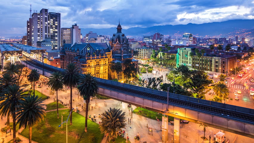Medellin, Colombia, time lapse view of downtown buildings and Plaza Botero square at dusk. Zoom out.