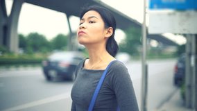 Young Asian Woman waiting at bus stop toned video 4k UHD (3840x2160)
