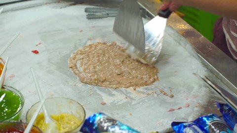 Process of making a handmade fruit icecream on an asian night market