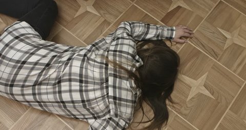 Unconscious or dead woman lying on floor.