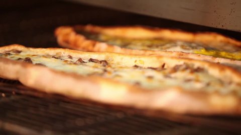 Turkish and Arabic Traditional Baked Ramadan Food Pide or Pizza ingredients with sliced halal lamb meat , butter, cheese and spicy herbs.
