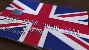 Plastic bank card featuring flag of Great Britain. National banking system related animation - Powered by Shutterstock - Get 15% off with code: PIKWIZARD15