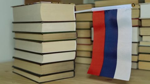 Russian flag on the background of books. Flag of Russia and paper books.