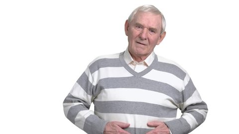 Old man with stomach problems. Mature man holding stomach with painful discomfort, white background. Abdominal pain in elderly persons.