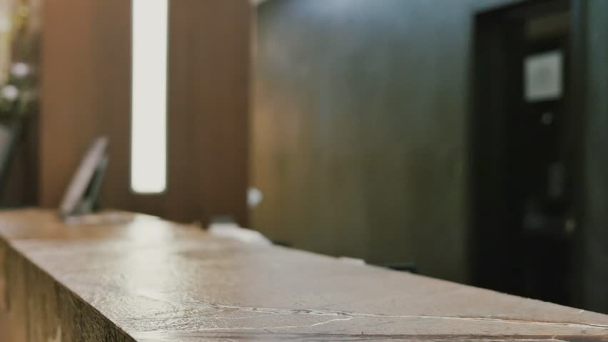 Businesswoman guest receives electric key to the hotel room at the reception. Check-in slow motion