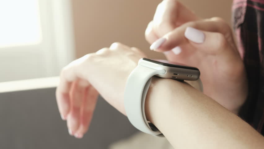 Woman using smartwatch touchscreen wearable technology device. Closeup. Smart watch on female wrist. Pretty girl making gestures on a smartwatch computer device Royalty-Free Stock Footage #1007872705