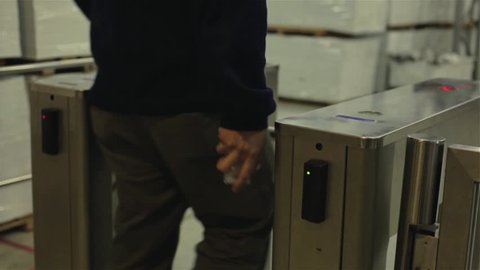Man passing a Turnstile using Electronic Card Key. Low Angle View.