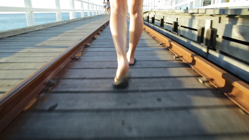Ground view walking at Busselton jetty in Busselton, Western Australia. Along the railway of the wooden pier in WA. Australia travel and freedom concept.