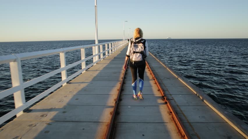 Western Australia travel freedom concept. Happy caucasian woman at Busselton jetty in Busselton, Western Australia. Female over iconic wooden pier in WA, Australia.