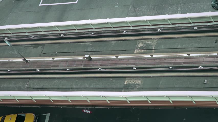 Aerial landscape elevated train travels over a line with traffic cars and people in street at taipei asian city. Cityscape modern metro system arriving at station-Dan