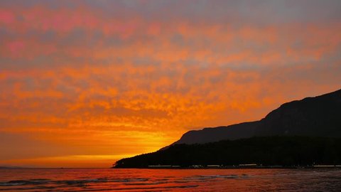 A crimson colored autumn sunset video from Akyaka coastline (Gulf of Gokova, Aegean Sea) with fiery altocumulus clouds.
