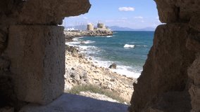 Rhodes old town port and Aegean sea from castle fort ruins window hole, Dodecanese, Greece
