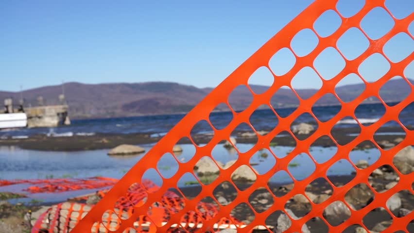 orange plastic sheet for road works in the wind