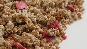 Muesli breakfast with strawberry flavor close-up 4K 2160p 30fps UltraHD footage - Morning meal with dehydrated crunchy cereals slow tilt 3840X2160 UHD video
