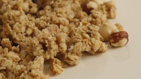 Close-up crunchy cereals on pile 4K 2160p 30fps UltraHD panning footage - Slow pan on muesli with hazelnuts flavor 3840X2160 UHD video
