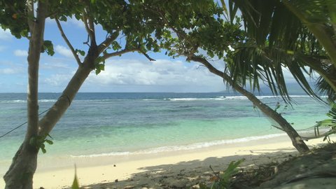ARIAL: Stunning sandy beach on Fiji with a pristine blue ocean view on a sunny day. Remote tranquil spot perfect for relaxation and to take some time off. Breathtaking summer holiday destination.
