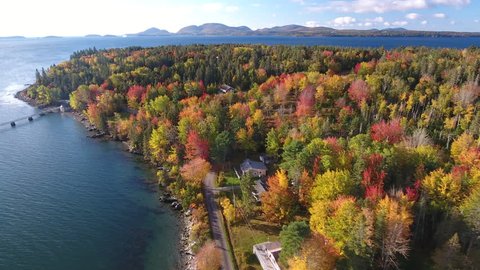 A breathtaking aerial view of Hancock, Maine looking across Mt Desert Narrows to Acadia National Park with the Fall colors in their peak. USA