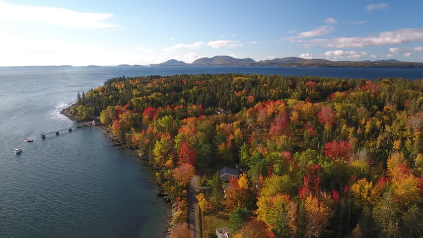 A breathtaking aerial view of Hancock, Maine looking across Mt Desert Narrows to Acadia National Park with the Fall colors in their peak. USA
