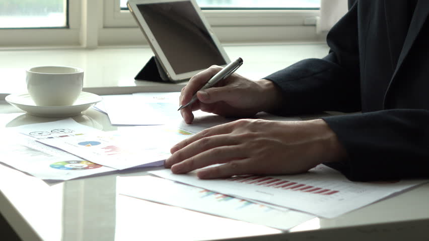 Man working with paperwork in the office. | Shutterstock HD Video #1007929303