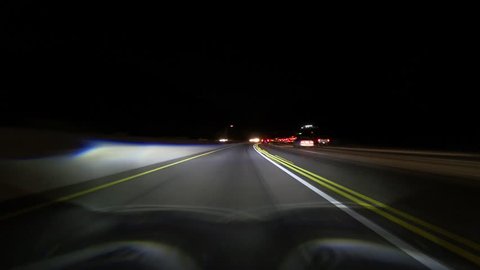 Night driving time lapse in the 405 south freeway car pool lane through the Sepulveda Pass and West Los Angeles in Southern California.