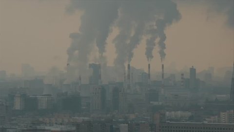 Air pollution by smoke coming out of factory chimneys