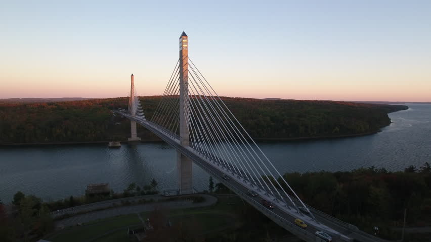 A stunning aerial view of Penobscot Narrows Bridge, Maine, USA over the Penobscot River and Verona Island with the Fall colors in their peak.