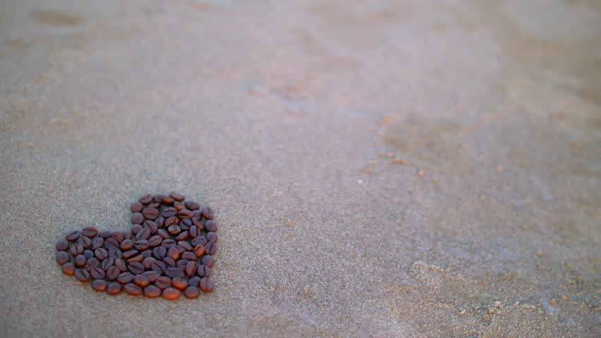 Heart laid out of grains on sand