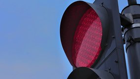 Traffic lights at road crossings. Red light close-up. Blinking light against sky background. Source: Canon EOS, graded. Clip ID: ax1306c
