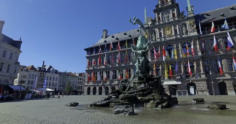 Antwerp, Belgium. Circa August 2017.Tourists visiting Bravo statue in Grat Market square in the center of the city on a sunny day. City Hall in the background. Cinematic camera movement.