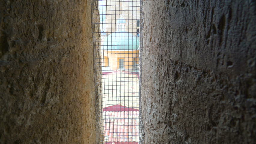 The small square on the railings on the church in Palermo Sicily Italy from a roof of the church and the view of the houses shigle roofs