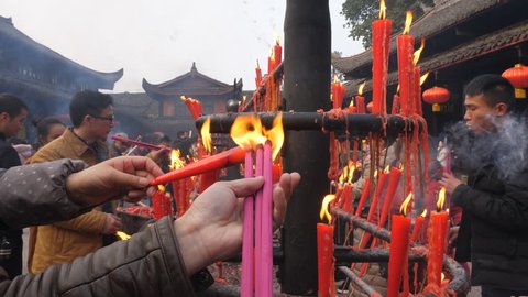  Feb.16,2018-Emei ,China:People burn incense  to pray in front of candlestick at Baoguo temple of Emei mountain at first day of Chinese New Year 2018