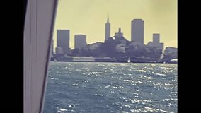 Alcatraz island in San Francisco Bay skyline. Sea view from boat touristic tour. Archival San Francisco restored footage in California, United States in 1980.