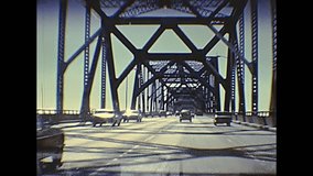 POV of vintage car crossing Oakland Bay Bridge passing by Treasure Island to Oakland. Archival footage in eighties. San Francisco, California, United States in 1980.