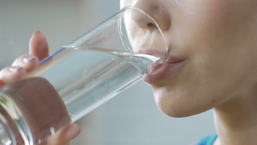 Girl drinking clean fresh mineral water glass, aqua body balance, hydration | Shutterstock HD Video #1007978305