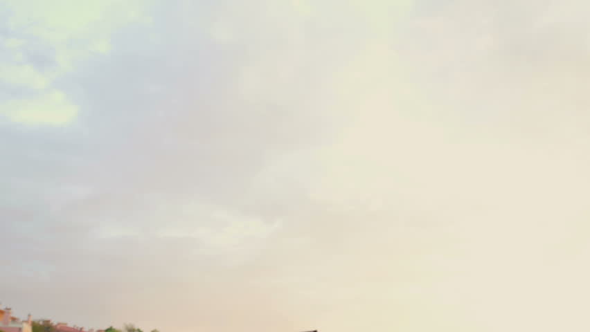 Young athletic man doing gymnastics on the sea early in the morning