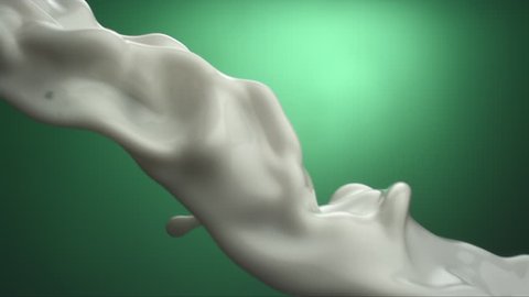 slow motion of a milk flowing on a green background