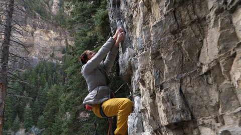 Tracking shot of woman rock climbing / American Fork Canyon, Utah, United States