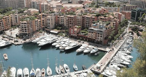 Monaco, Fontvieille, 28 May 2017: Video on port Fontvieille from Monaco Ville and Prince Palace of Monaco, parking of mega yacht next luxury apartments, a lot of boats, restaurants on embankment