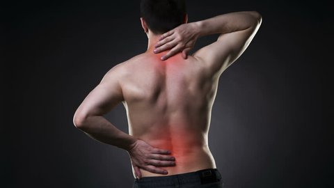 Back pain, man with backache on black background with red dots