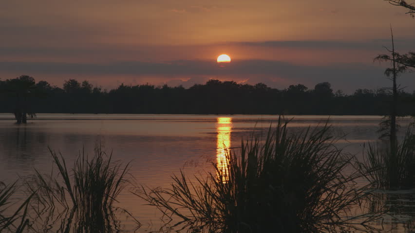 sunset over the Mississippi River, nice clouds in front of sun