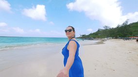 
Professional video of POV woman leading boyfriend to the beach in hawaii in 4k slow motion 60fps