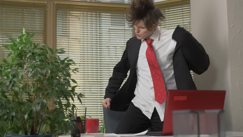 Young man in a suit dances in the office, makes funny faces, fools around, rejoices. Work in the office concept 60 fps Royalty-Free Stock Footage #1007995138